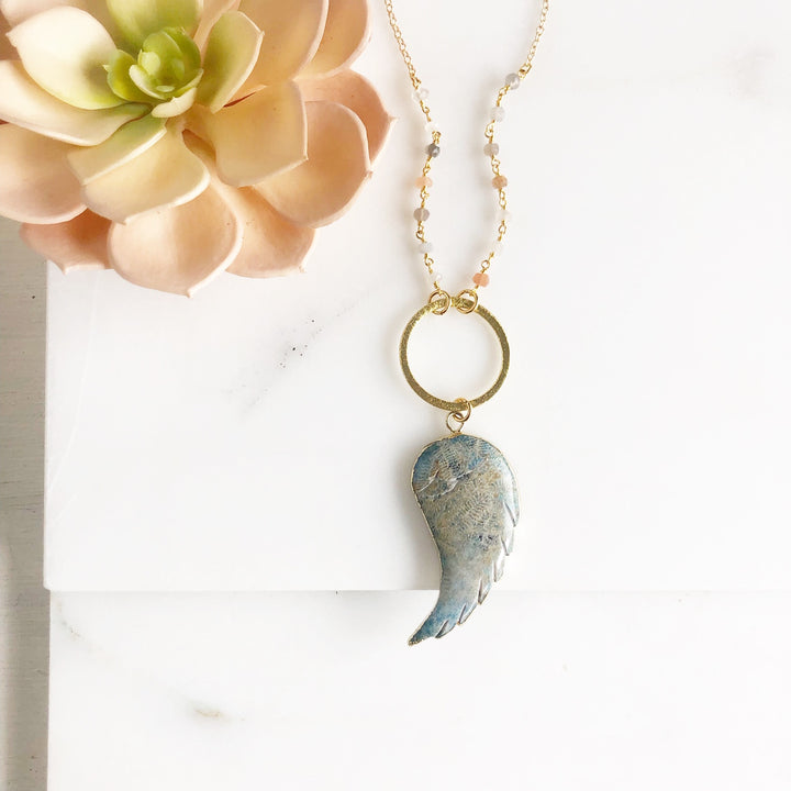 Long Wing Necklace in Shades of Blue with Textured Circle and Moonstone Beading in Gold.