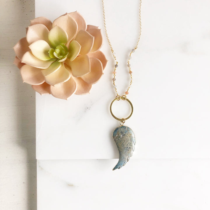 Long Wing Necklace in Shades of Blue with Textured Circle and Moonstone Beading in Gold.